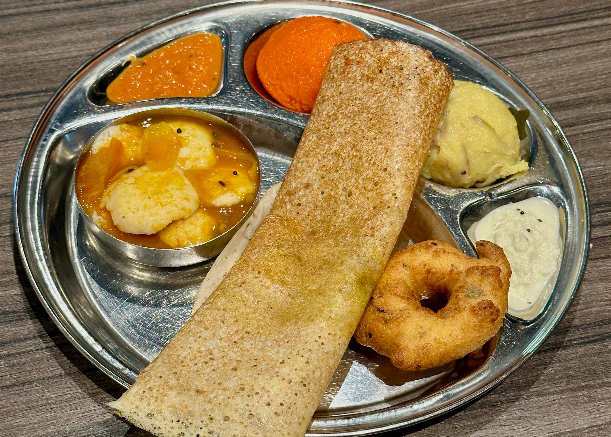 My mini tiffin in Sangeetha Restaurant in Kuala Lumpur. The mini idlis are on the bottom left, and the dosa is the long crepe in the middle.